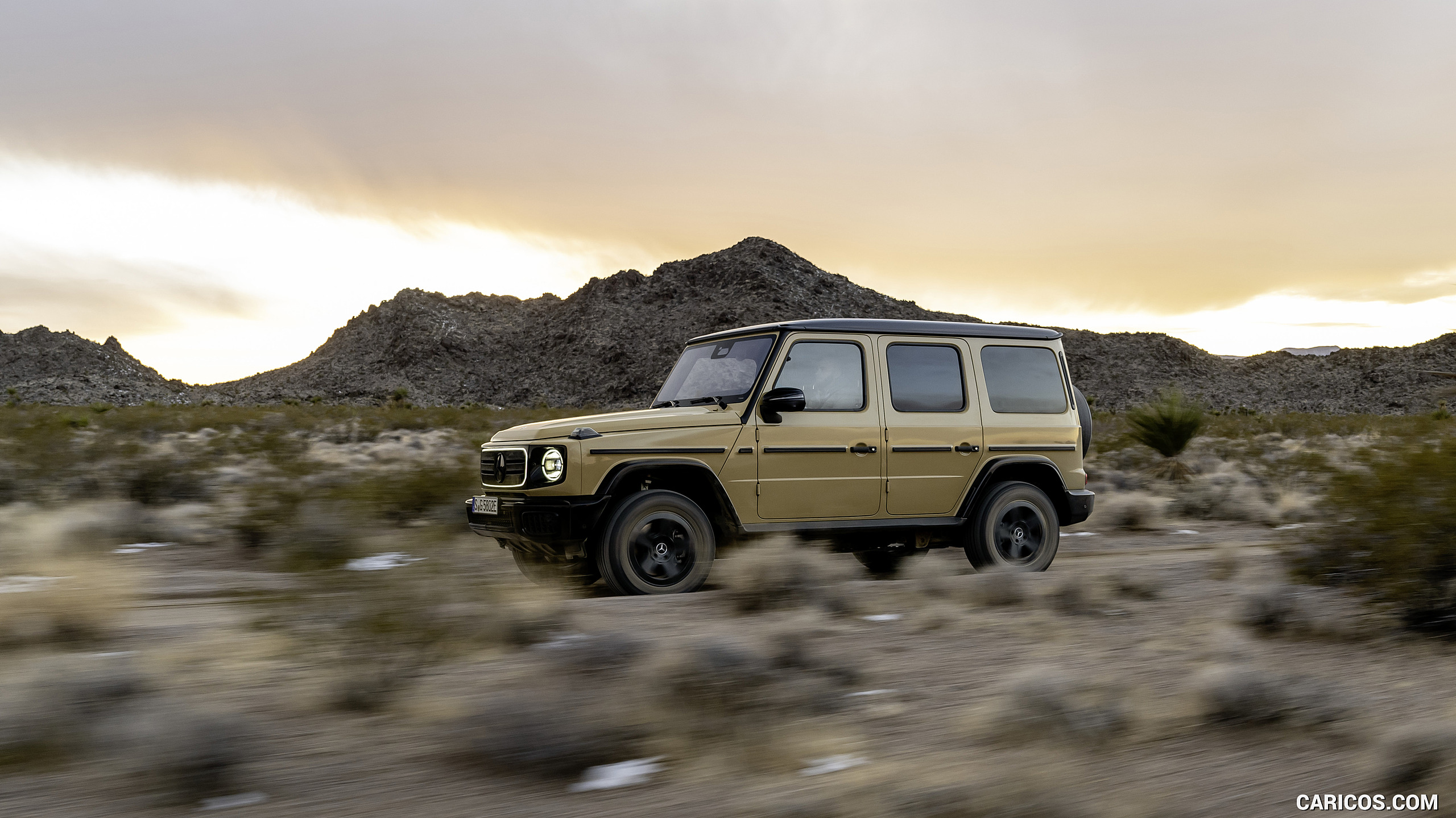 2025 Mercedes-Benz G 580 Electric with EQ Technology (Color: MANUFAKTUR Desert Sand Non-Metallic) - Front Three-Quarter, #34 of 227